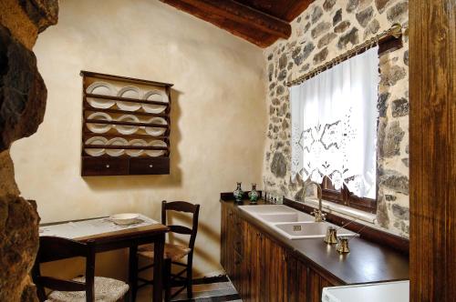 KapetanianáThalori Traditional Ecotourism Village的一间带水槽、桌子和窗户的浴室