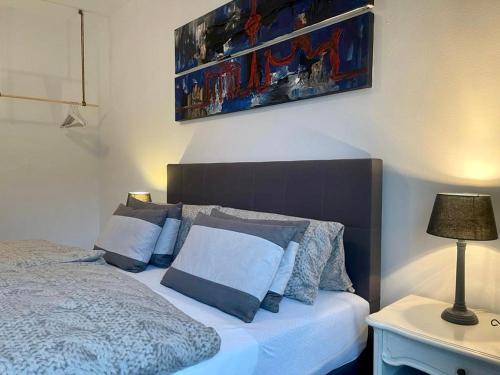 柏林COSY PANKOW HOMES - Studios mit TV Stick的一间卧室配有一张床和一张带台灯的桌子