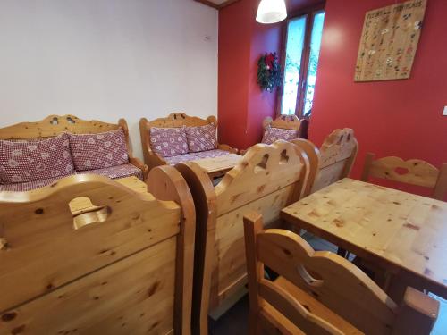 勒弗勒内-杜瓦桑Auberge du Freney的客房设有一张木床和一张桌子及椅子。