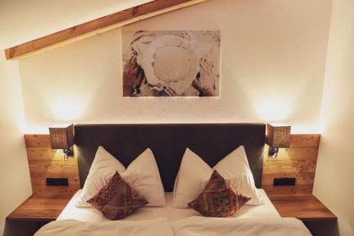 基茨比厄尔Mocking Ferienappartements的卧室配有带枕头的床铺和墙上的绘画