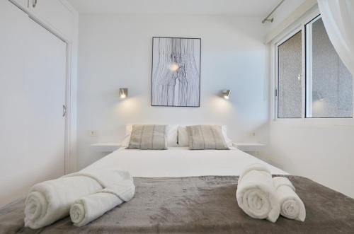 圣地亚哥港Costa Isora的白色卧室配有一张大床和毛巾