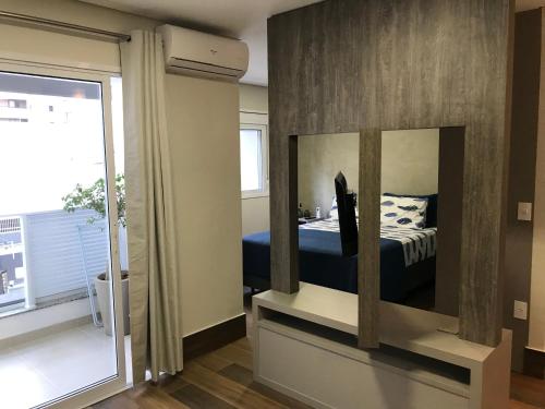 坎皮纳斯Moderno, excelente custo-benefício e localização.的一间卧室配有一张床和一面大镜子
