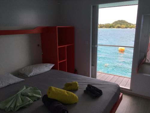 勒马兰Aqualodge Martinique的一间卧室配有一张床,享有水景