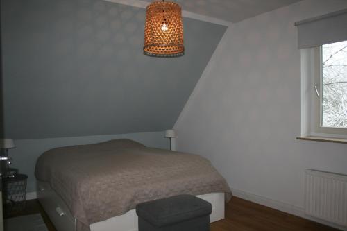 Hönisch3-Zi. Wohnung in Verden/Hönisch- 24_7 self-check-in的一间卧室配有床和灯具