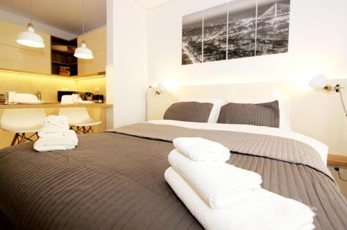 贝尔格莱德Apartment SUN CITY 1的一间卧室配有两张床和白色毛巾。