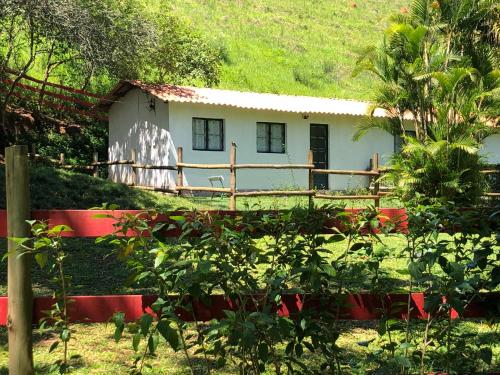 康赛瓦托利亚Vivenda dos Guaranys: casa + loft的前面有红墙的白色小房子