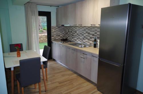 斯卡拉索提罗斯Anesis Luxury Apartments的厨房配有不锈钢冰箱和桌子