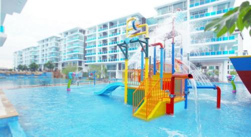 华欣D411 My Resort Huahin的一个带水上公园的游泳池,并设有一个游乐场