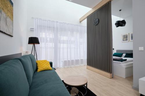 弗罗茨瓦夫Green Ande的一间带绿色沙发的客厅和一间卧室