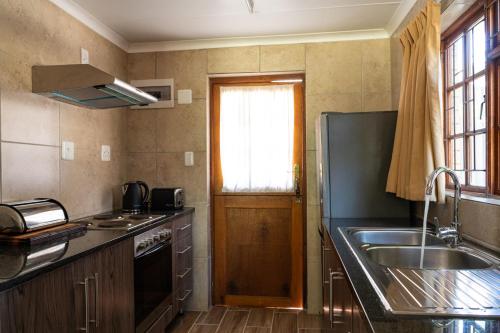 Hou MoedDe Hollandsche Molen的一个带水槽和窗户的小厨房