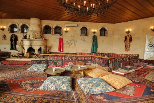 内夫谢希尔Emin Koçak Hotel Kapadokya的客厅配有沙发和枕头,位于地板上