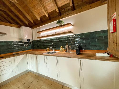 丰沙尔Mountain Eco Shelters 2的厨房配有白色橱柜和木制台面