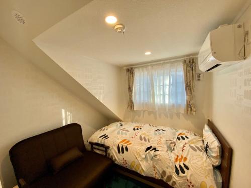 轻井泽Polar House ShinKaruisawa1 - Vacation STAY 00271v的一间带床和沙发的小卧室