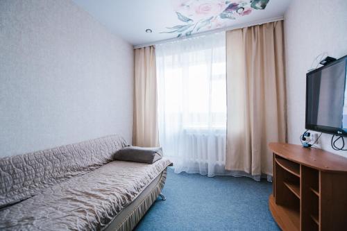 赤塔Dekabrist ul. Serova 30的一间配备有沙发及电视的酒店客房