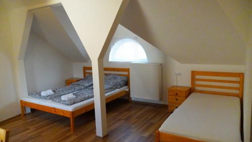 米什科尔茨Pajkos Póni Vendégház的一间卧室设有两张床和窗户。