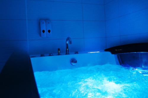 南特Chrysalide cocon的蓝色的浴室设有充满蓝色水的浴缸