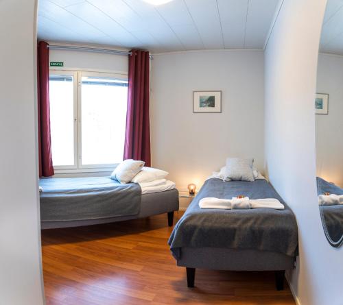 KontiolahtiMotelli Kontio的一间卧室设有两张床和窗户。