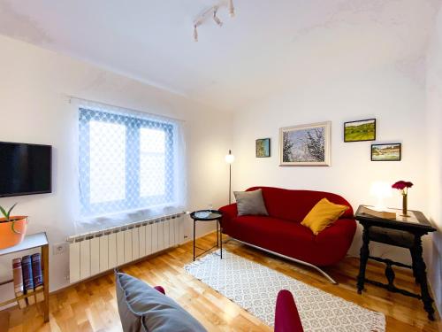 萨格勒布Apartment Mletačka的客厅配有红色沙发和电视