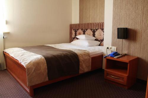 Malnia林德酒店的酒店客房,设有床铺和床头柜