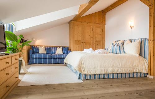 安纳贝格-伦格茨Winterstellgut的一间卧室配有一张床和一张蓝色的沙发