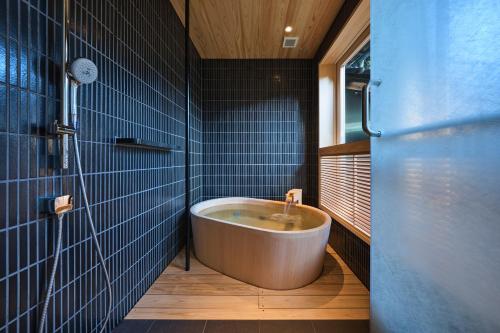 丰冈市西村屋 本馆的浴室设有浴缸,铺有蓝色瓷砖。