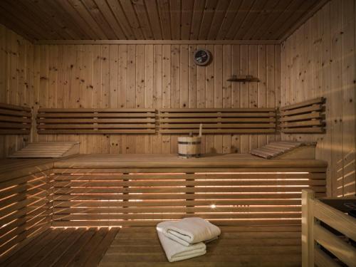 塔克森巴赫Chalet Wolfbachgut的铺有木地板的带2条毛巾的桑拿浴室