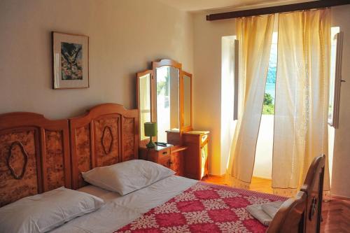 科尔丘拉Charming House Ruža in Korčula Town的一间卧室设有一张床和一个大窗户