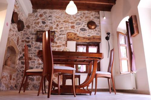 玛利亚The Old House Cottage的一间带木桌和椅子的用餐室