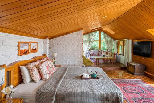 西姆拉SaffronStays Ekam, Chail - forest villa near Chail cricket ground的一间卧室,卧室内配有一张大床