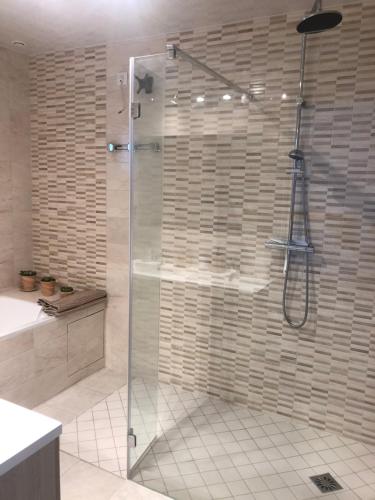 普里西尼Gîte des vignes的浴室里设有玻璃门淋浴