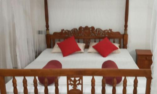 贝鲁沃勒Coral Reef Guest的一间卧室配有红色枕头的床