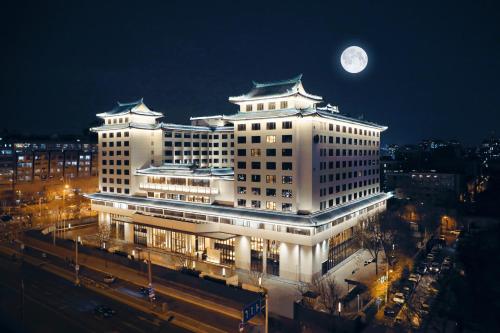 北京北京华侨大厦睿世酒店的天空中月亮的白色大建筑