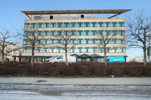 索伦蒂纳Stockholm Hotel Apartments Sollentuna的停在大楼前的白色汽车