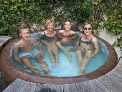 万根沃格Haus Strandburg的一组坐在热水浴缸中的人