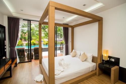 拉威海滩Z&Z House的卧室设有一张白色床,享有游泳池的景色