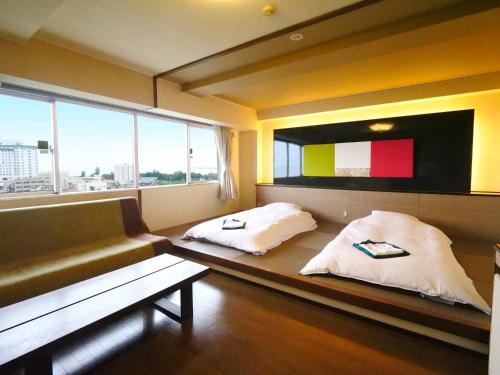 长滨米娜托坎绿色酒店客房内的一张或多张床位