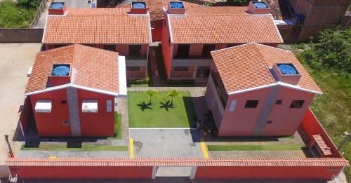 马拉戈日Casa Lua Cheia na Praia de Peroba, Maragogi的享有红色屋顶房屋的顶部景色