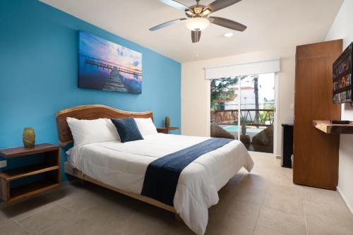 坎昆Villa Sofía Holiday Accommodation的一间卧室配有一张蓝色墙壁的床