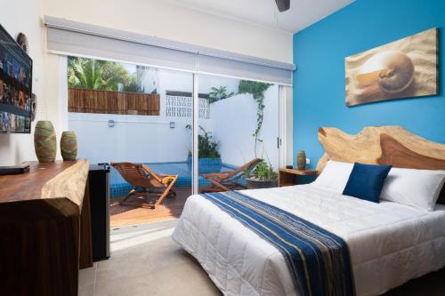 坎昆Villa Sofía Holiday Accommodation的一间卧室设有一张床和一个滑动玻璃门