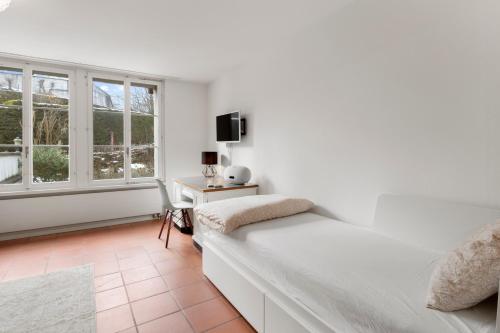 戈尔道Cozy Boutique Apartment at Mt. Rigi的白色的卧室设有床和窗户