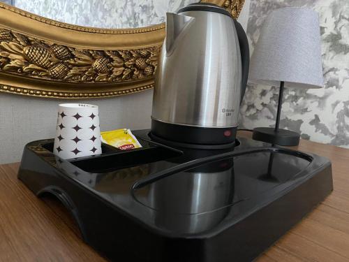 巴勒克埃西尔Özdemir Otel的台灯旁的桌子上的咖啡壶