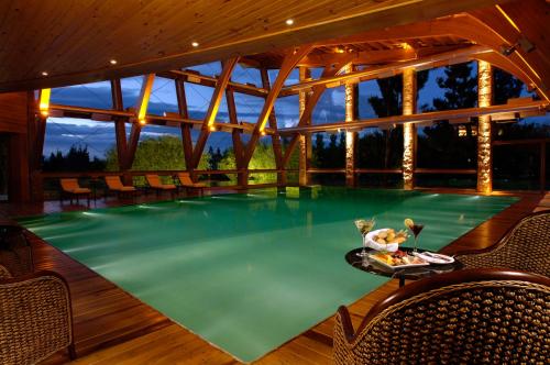 埃尔卡拉法特洛斯阿拉莫斯波萨达旅馆的一座带桌椅的别墅内的游泳池