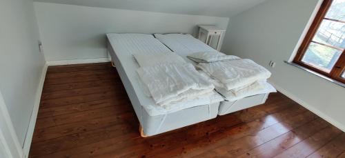 南泰利耶Beautiful apartment close to lake Mälaren的一张带白色床单和枕头的床