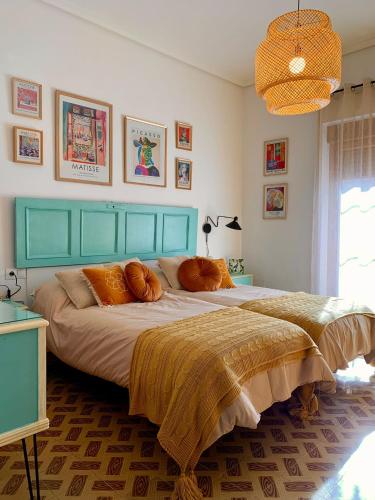 蓬费拉达Alojamiento estilo Boho con mucho encanto的一间卧室配有一张带橙色枕头的大床
