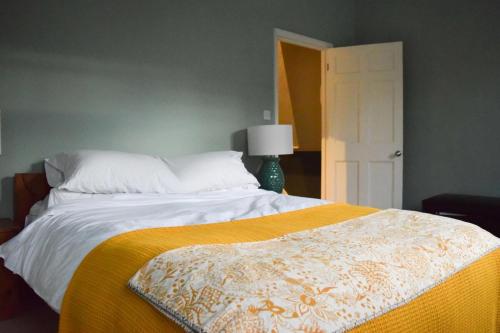 伦敦Stylish and Spacious Apartment with Terrace的一间卧室配有一张带黄色毯子的大床