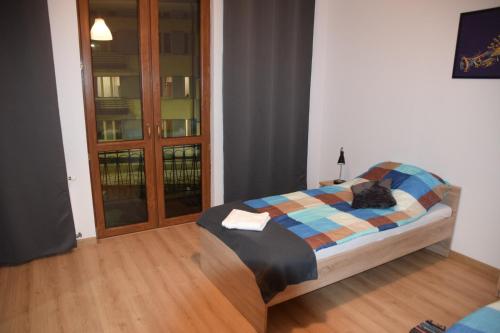 扎莫希奇Apartament Sienkiewicza 8的一间卧室配有一张带铺着平底毯的床