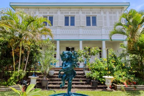 圣皮埃尔Villa Myriam的棕榈树屋前的雕像