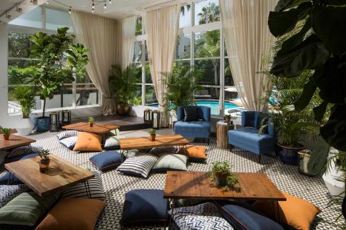 迈阿密海滩Generator Miami的客厅配有桌子、沙发和植物