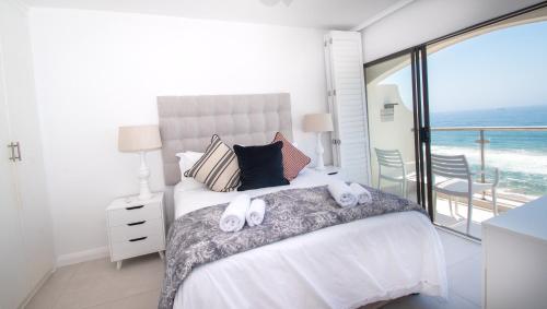 德班1002 Bermudas - by Stay in Umhlanga的一间卧室配有一张床,上面有两条毛巾