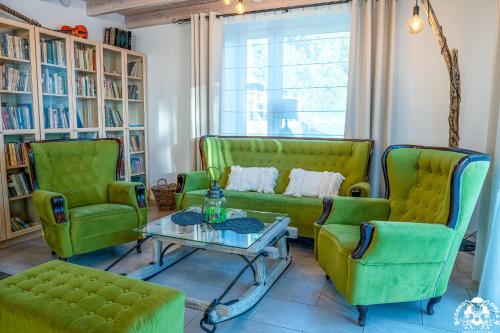 ŻabnicaAgroturystyka Corno Owca的客厅配有两张绿色椅子和一张桌子